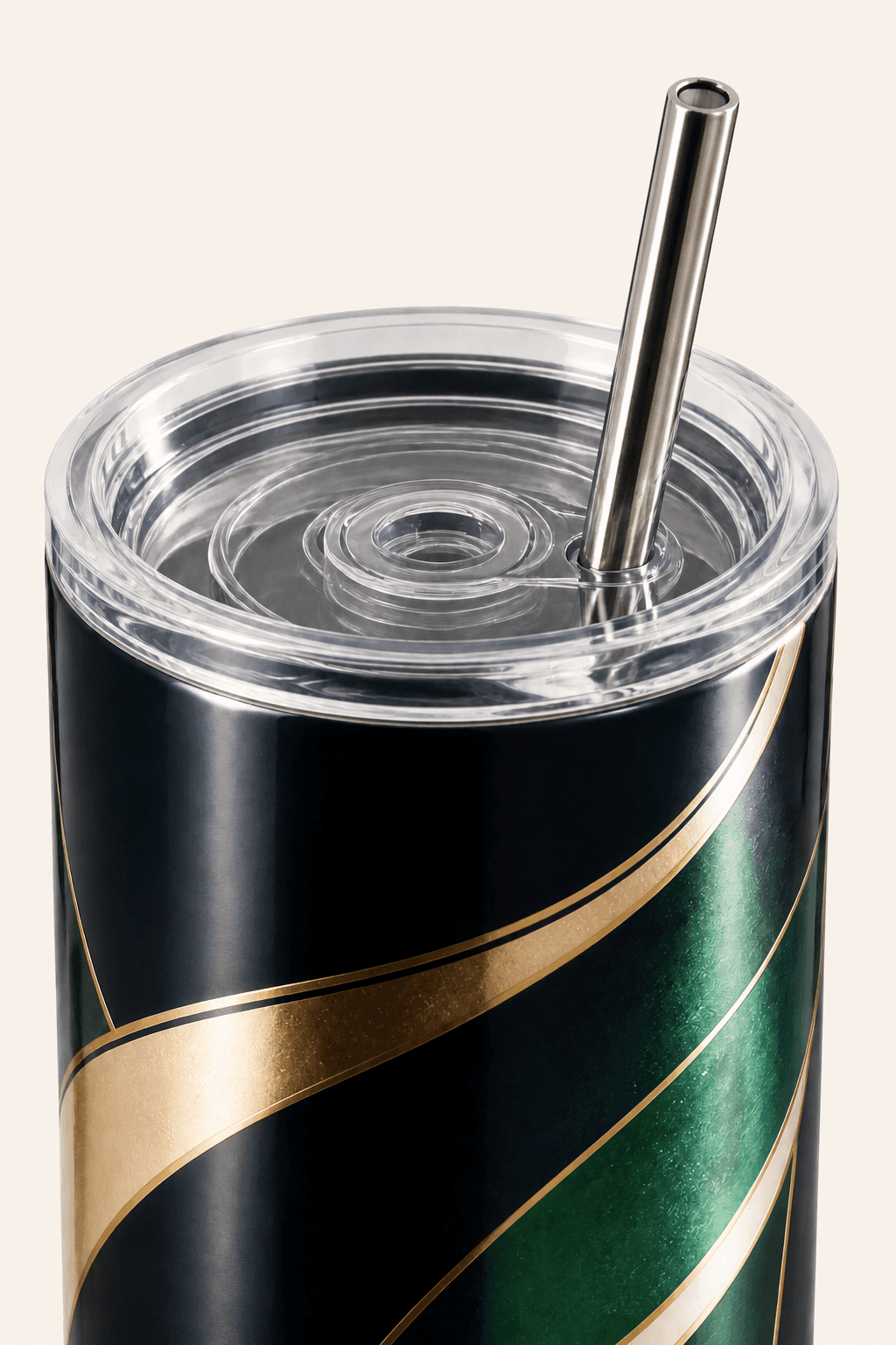 Close view of a custom tumbler's clear lid, straw, and navy, emerald, ivory, and gold wrap.